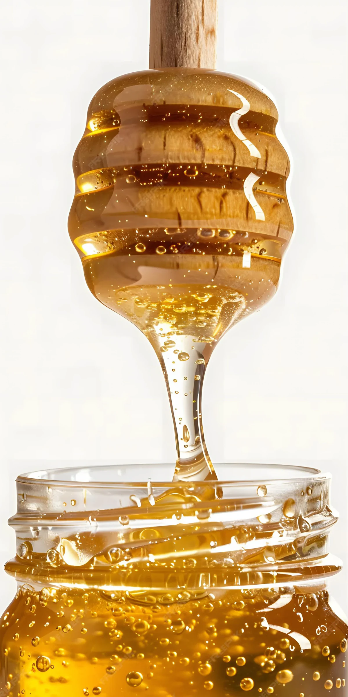 Honey dripping from a wooden dipper
